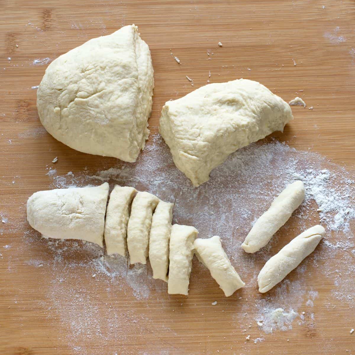 Příprava bramborových šišek, vyvalování na pomoučeném vále.